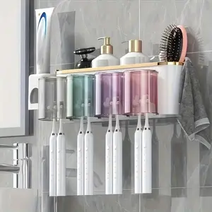 Hole-Free Wall Mounted Bathroom Storage Rack, equipped with toothbrush holder . Features transparent shelf, modern white and gold finish. Space-saving & sturdy construction, ideal for neat bathroom organization.