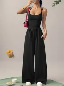 Available in multiple colors; European/American style solid color halter camisole jumpsuit for women featuring ruched high waist, drapey floor-length wide legs; spring/summer casual vacation loose sleeveless jumpsuit