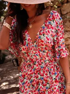 A long V-neck dress for women with a rich floral print and a cinched waist, featuring a romantic and fresh style with a touch of vintage charm. Perfect for relaxed and romantic occasions such as countryside getaways, outdoor afternoon tea, or light spring