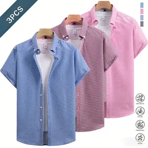 Three plaid men’s short sleeve shirts in a business casual style featuring a classic notched collar design that is sharp and well structured. A pink and white plaid contrast collar adds refined details, while white front buttons enhance the texture. The s