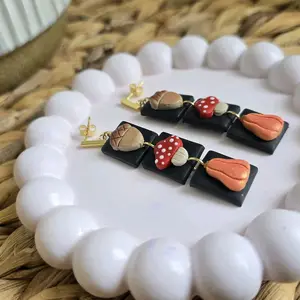 Handmade Polymer Clay Earrings with Fall Designs 3 Tier Featuring Mushroom Acorn and Squash Pumpkin on Black Background