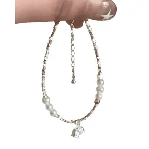 Denise's elegant bell and pearl bracelet with silver accents, a high-end niche design piece, unique and fresh jewelry