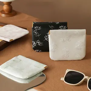 A modern-style snap pouch for storing lipstick, keys, makeup, coins, or charging cables.