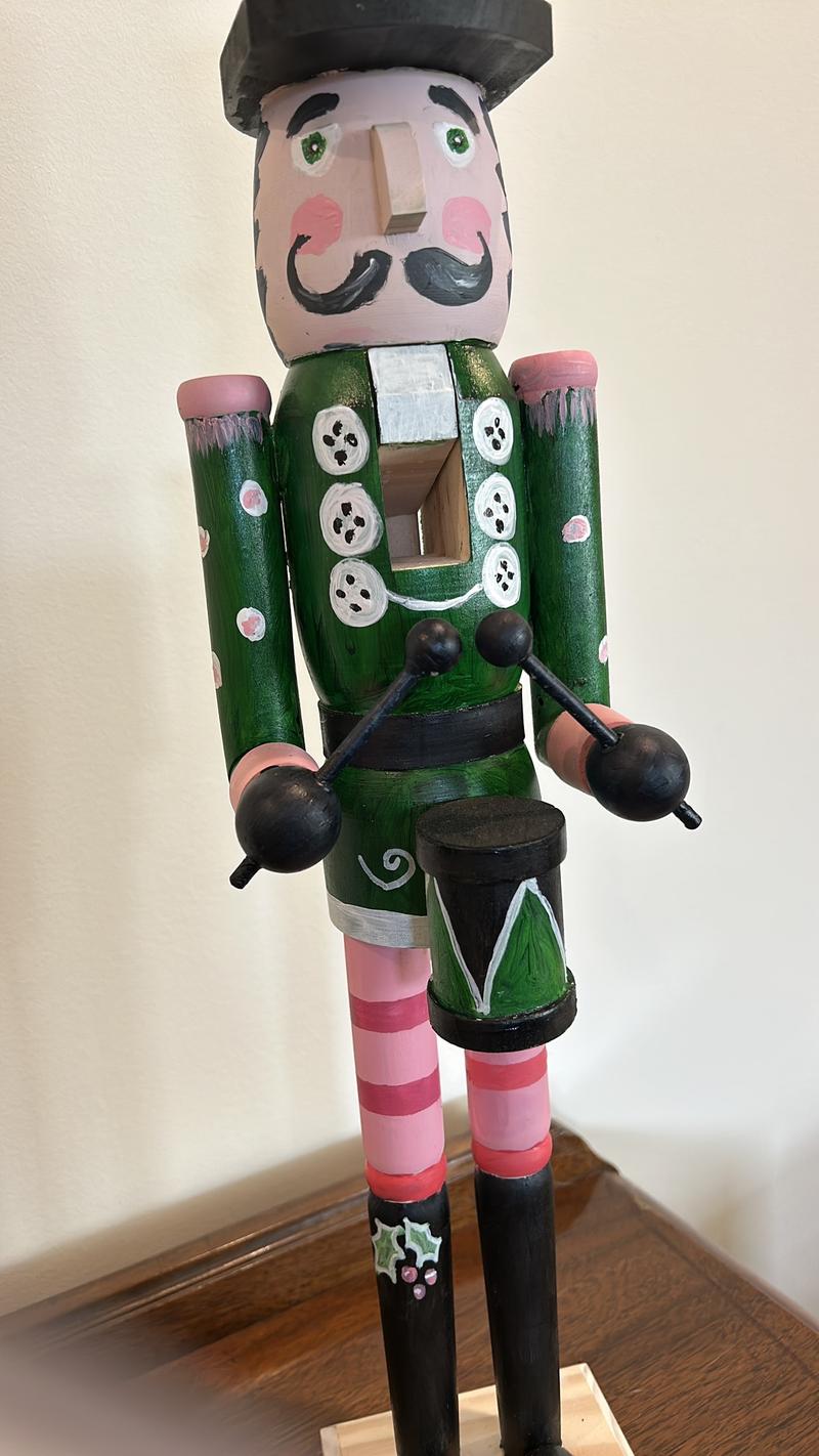 Hand-painted wooden nutcracker. He measures 24 inches tall. “Gunner” is a handsome guy that absolutely can live in your space year round.