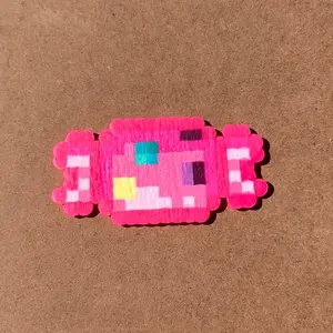 Piece of pink candy made from perler beads