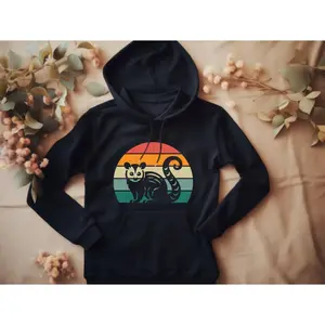 Women's possum and nature-themed apparel for animal lovers Graphic Hoodie - Long Sleeve Pullover Regular Fit | Soft & Breathable Fabric, Durable Print, Everyday Comfort, Machine Washable, retro vintage with a colorful sunset design flat lay of hoodie on a