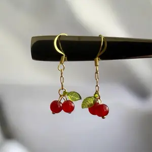 Handmade Cherry Bead Earrings with Glossy Red Cherries Translucent Green Leaves Gold Tone Chain Lightweight Fishhook Ear Wires Perfect for Everyday Wear or Gifting