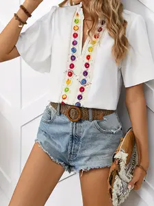 A women's white short-sleeve chiffon blouse with vintage ethnic-style elements, featuring a V-neckline and loose bell sleeves, suitable for everyday work or casual home wear.