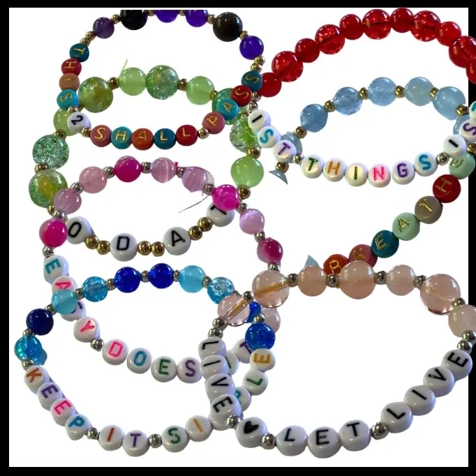 Motivational stretch bracelets, recovery slogans and other words spelled out in letters. Many quotes and colors.