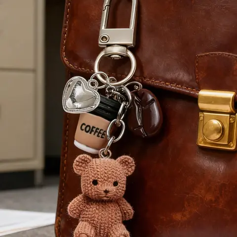 A coffee teddy bear keychain bag charm, a cute, stylish and accessory for your bag and keys! This charm includes a knitted teddy bear, a mini coffee cup, a coffee bean, and a sparkling heart pendant Keychain For Bags