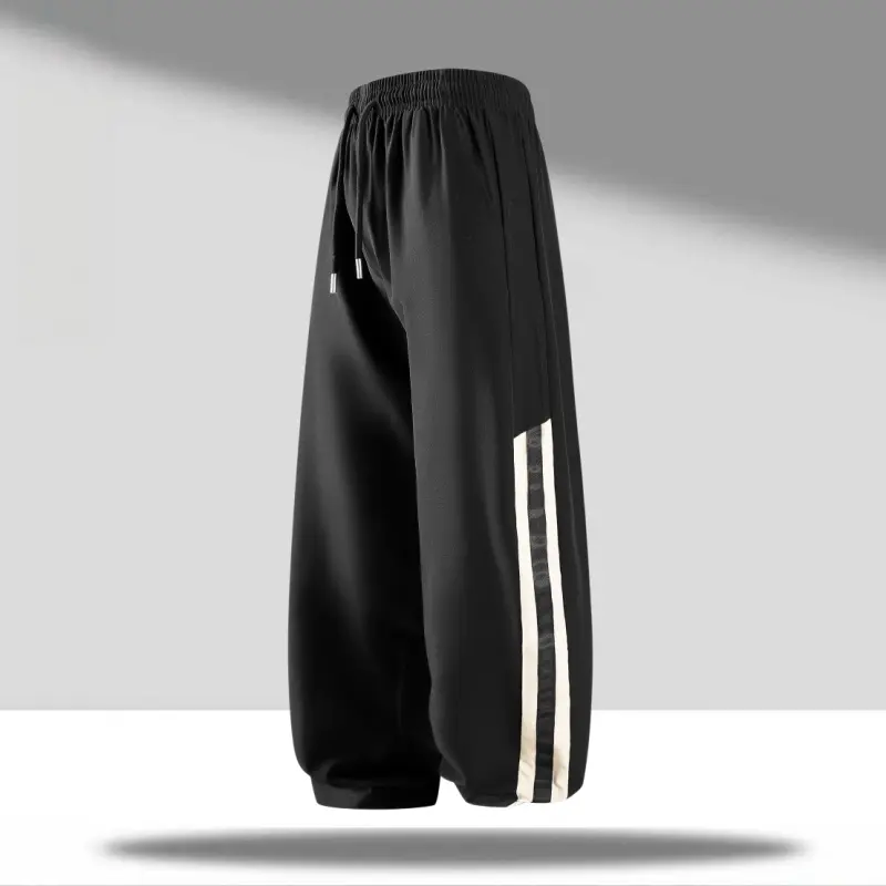 Unisex convertible jogger pants with wide legs and double white stripes on the side – lightweight smooth woven fabric, elastic drawstring waist, adjustable cuffs, breathable, American high street style for gym, skate, and commuting