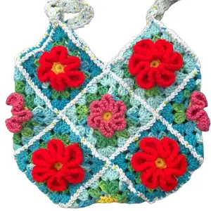 Crocheted 3D Flower Bag - Colorful Handmade Design with Red and Pink Flowers on Blue Background