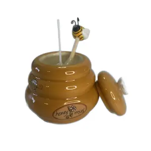Beeswax candle in a honey pot