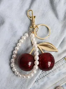 Fashionable retro bag accessories featuring a cherry keychain; minimalist, sweet cherry ornament accessory; small gift for female friends; holiday gift; cherry gold chain handbag pendant strap with a pearl string tassel.