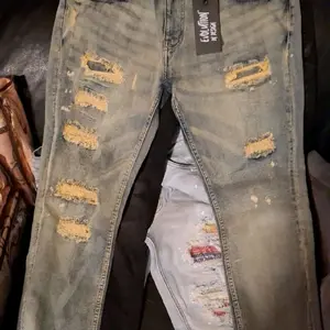 Menswear Man Ripped Denim Jeans with Distressed Look and Unique Design