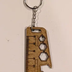 Ruler keychain with markings.