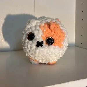 Loaf Cat Adorable Crochet Toy with Orange and White Colors and Black Eyes Perfect for Collectors