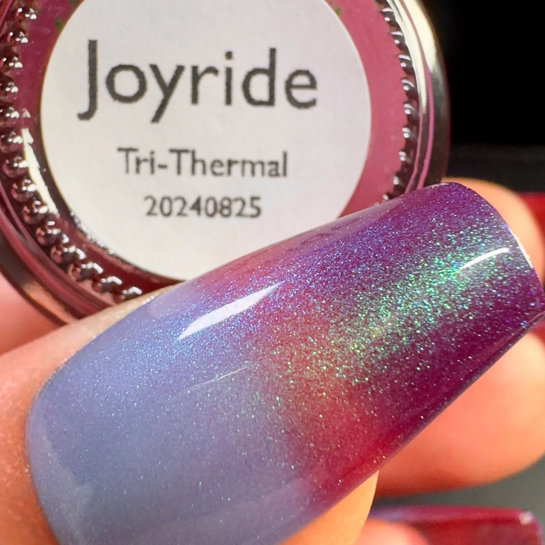 Joyride Tri-Thermal Nail Polish by Drunk Fairy Polish | Cold Is Dark Eggplant, Medium Is Red Violet and the Warm State Is Baby Blue. It Has a Fine Particle Aurora Shimmer on Top That Goes From Emerald Green to Blue to Violet thermal polish