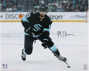 Matty Beniers Seattle Kraken Autographed 16" x 20" Navy Jersey with Puck Photograph - Fanatics Authentic Certified