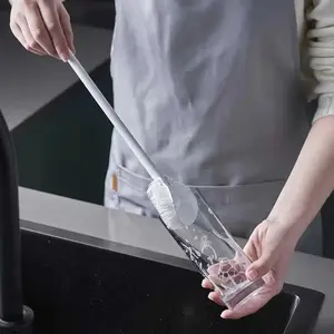 Using a long handled bottle brush, suitable for cleaning narrow mouthed containers, vacuum sports water bottles, thermos cups, and glassware