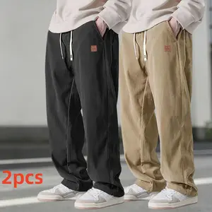 Two men's autumn casual pants featuring a simple and versatile style with drawstring design, adding a casual feel. The pants have delicate small details, such as stitching accents, making them comfortable and stylish. The loose fit provides comfort and fr