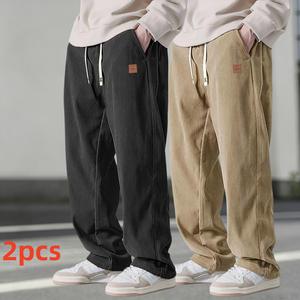 Two men's autumn casual pants featuring a simple and versatile style with drawstring design, adding a casual feel. The pants have delicate small details, such as stitching accents, making them comfortable and stylish. The loose fit provides comfort and fr
