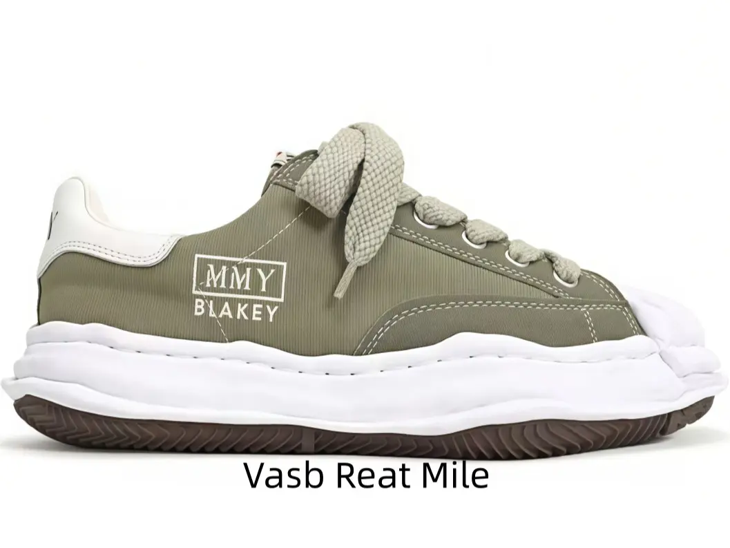 Sleek matte olive green leather low-top platform shell toe shoes coordinate casual shorts nicely, shock-absorbing thick white sole balances minimalist earth tone design and long-time walking comfort.