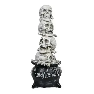 38 in. Halloween Stacked Skulls in a Cauldron Tabletop Decoration