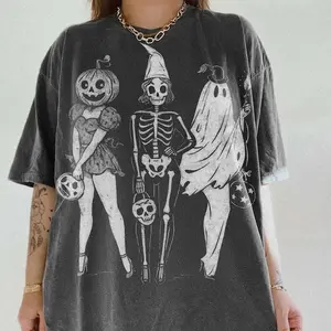 Get in the Halloween spirit with this retro-inspired graphic tee! Featuring a fabulous trio of ghouls — a pumpkin-headed pin-up, a vintage skeleton, and a sassy ghost — this shirt is all about spooky with style. Perfect for fall festivals, pumpkin patches
