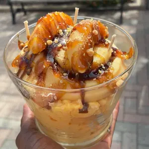 Peach Cobbler Cinnamon Roll with Caramel Sauce and Crumbled Toppings for a Sweet Treat