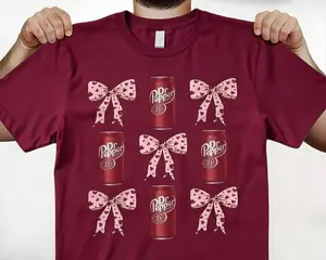 [SALE UP TO 50%] Cute Dr Pepper Can & Pink Bow Graphic T-Shirt / Sweatshirt / Hoodie – Burgundy Coquette Vintage Drink Lover Style, Gift for Soda Fans & Sweetheart Aesthetic Lovers