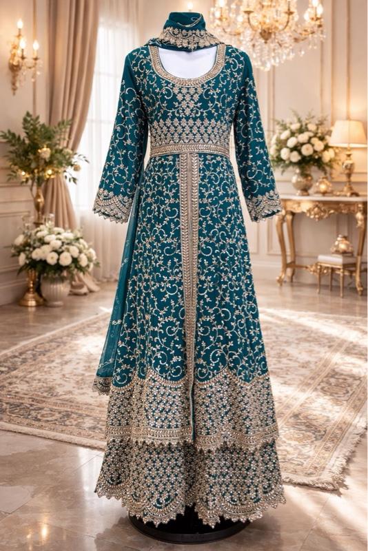 This image shows a green designer heavy embroidered bridal lehenga or Anarkali suit suited for traditional Indian weddings. Womenswear