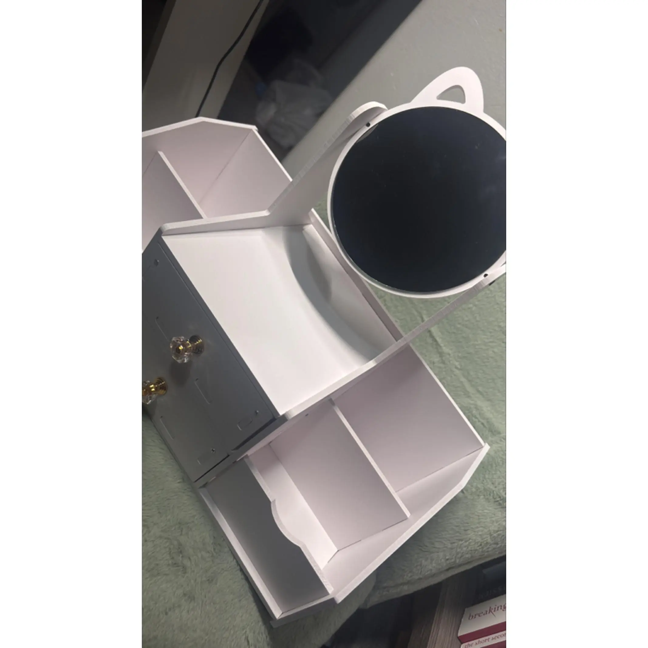 White Storage Box with Multiple Compartments and a Round Opening for Organizing Items