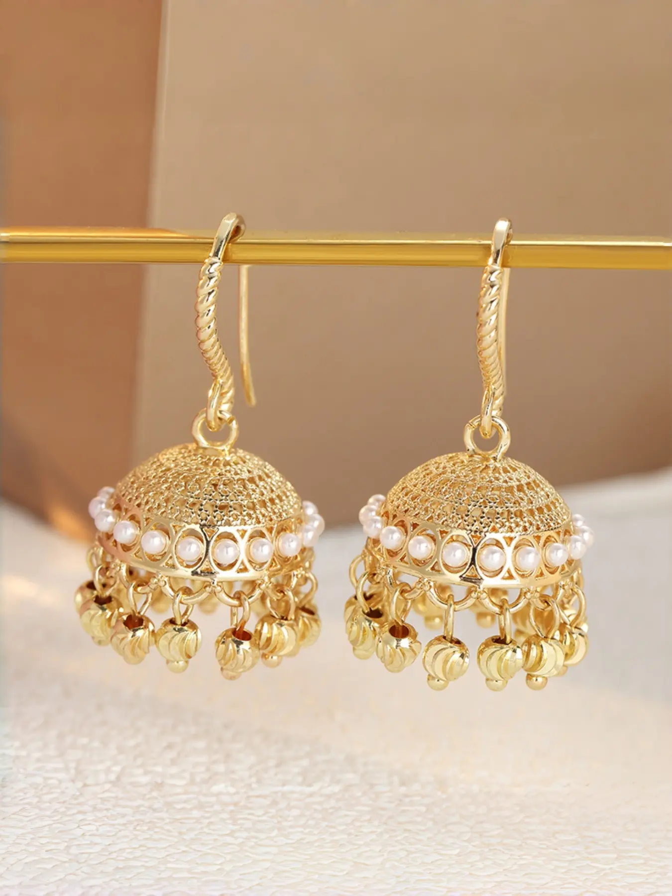 Palace Style Hollowed Out Bell Earrings with White Bead Trim, Three-dimensional Design with Retro Atmosphere, Versatile Women's Earrings for Vacation Banquets