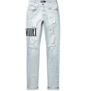 1135398 Amiri Embroidered Logo Distressed Jeans Lightwash