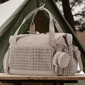A spacious multifunctional diaper bag with a adjustable long shoulder strap, perfect for parents. This quilted travel bag can also be used as a hospital bag for childbirth and obstetrics