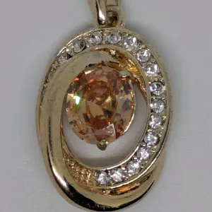 womens Gold-Plated Oval Pendant with Champagne Center Stone & CZ Halo.