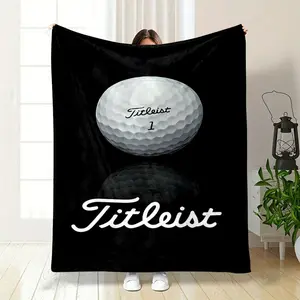 Golf lovers alert This cozy blanket features a crisp close up of a classic Titleist number 1 golf ball with its sleek reflection against a deep black background The iconic Titleist script stands ou