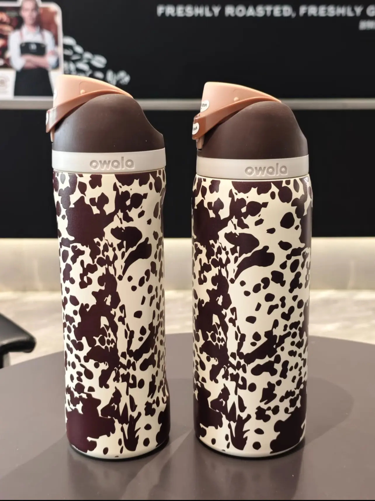 Owala cow-print insulated tumbler—featuring a large 32oz capacity and stainless steel construction, it keeps drinks hot or cold for extended periods. Perfect for iced drinks in summer and hot beverages in winter, it’s suitable for any setting.
