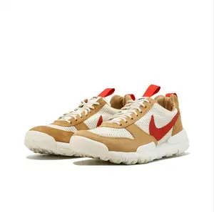 Earthy tones meet bold red accents — this shoe blends rugged utility with street-ready style. The breathable mesh upper keeps feet cool, while the cushioned midsole absorbs impact for all-day comfort.