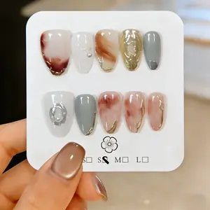 10 Pieces Handmade Press-On Nails, Almond-Shaped False Nails with Amber Tie-Dye, White Pearl Decor and Gold Mirror Powder Effect. Gorgeous and elegant, they lengthen fingers and brighten skin tone. Reusable, easy to apply and remove, ideal for girls and w