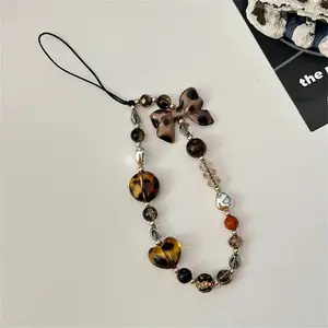 Leopard print bowknot beaded phone chain, a fashionable short wrist accessory design, a multi-functional retro pendant specially created for women, a practical accessory for phone case anti-loss lanyard, Phone Charms, Phone Wrist Strap, Vintage