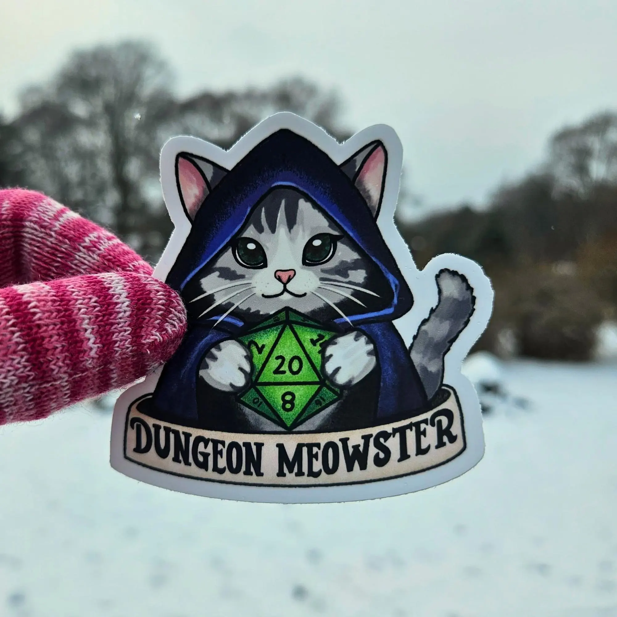 Dungeon Meowster D20 Sticker - Waterproof Vinyl Decal, Fantasy Cat Holding D20 Dice, TTRPG Tabletop Roleplaying Gamer Gift for Dungeon Masters