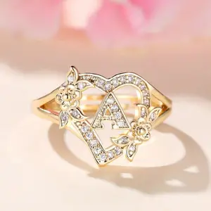Heart-shaped initial ring in 14k gold plating, adorned with delicate Cubic Zirconia stones, featuring 26 letters A-Z, personalized engraving, floral design, adjustable size, open style, suitable for women.