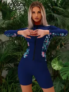 Briza｜Long Sleeve Zip Front One Piece Swimsuit For Women, One Piece Bathing Suit In Navy Floral With Swim Shirt Coverage And Boyleg Shorts As Vacation Swimwear For Women On Beach Surf Days, Quick Dry Comfort, And Confident Full Coverage