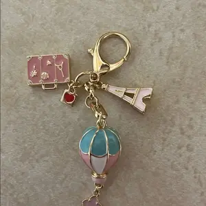 Eye Keychain with Eiffel Tower Charm, Hot Air Balloon, and Pink Suitcase Design