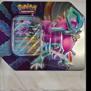 Pokémon TCG Paradox Destinies Tin Includes 5 Booster Packs.