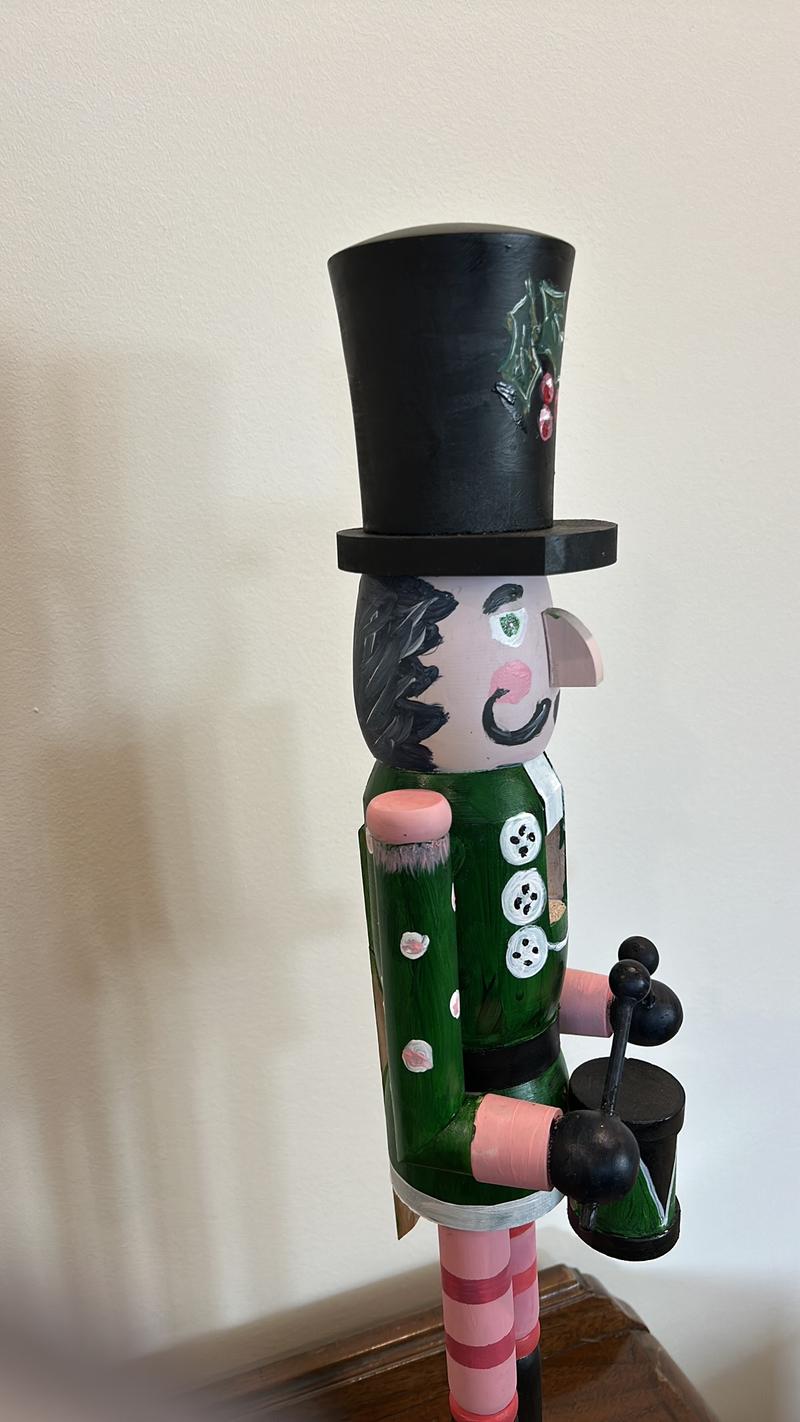 Hand-painted wooden nutcracker. He measures 24 inches tall. “Gunner” is a handsome guy that absolutely can live in your space year round.