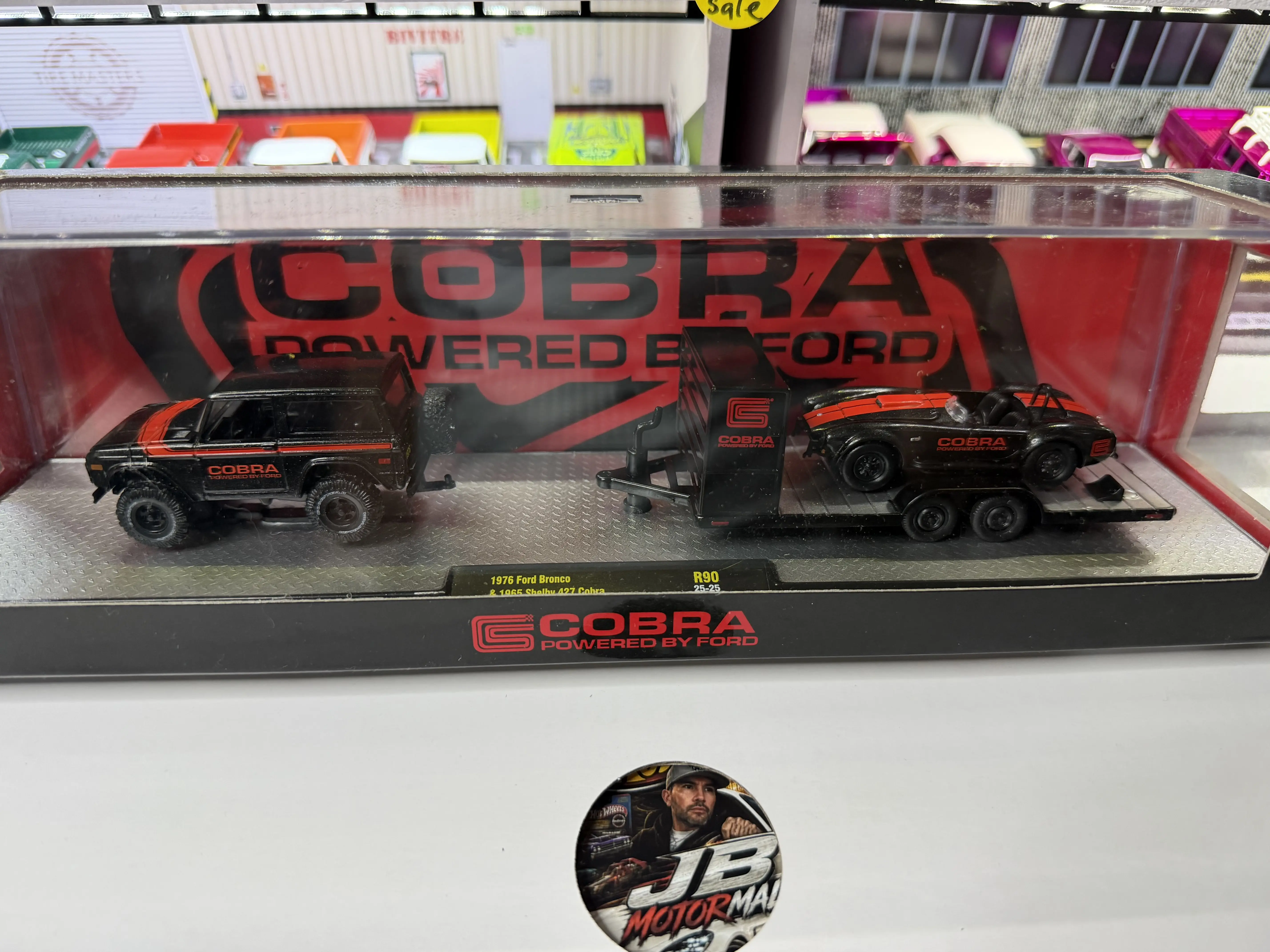 M2 Machines Release 90 Auto-Haulers Model Cars Set - 1976 Ford Bronco, 1965 Shelby 427 Cobra with Cobra Branding & Trailer