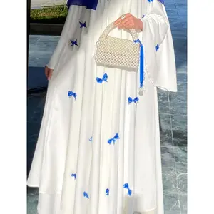 NewElegant White Abaya with Blue Bow Accents - Modest, Spring/Fall Fashion, Long Sleeve, Perfect for Arabian & Middle Eastern Attire, Modest Clothing|       Elegant Abaya|       Detailed Fabric